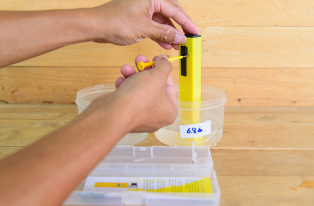The man calibrate Ph meter before use it for testerの写真素材