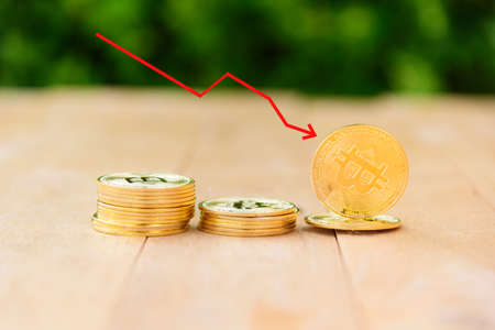 Bitcoin stocks fall. Red arrow show Bitcoin falling downの写真素材