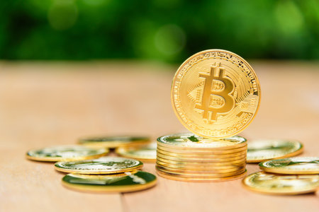 Closeup to Golden Bitcoin cryptocurrency on the wood plateの写真素材