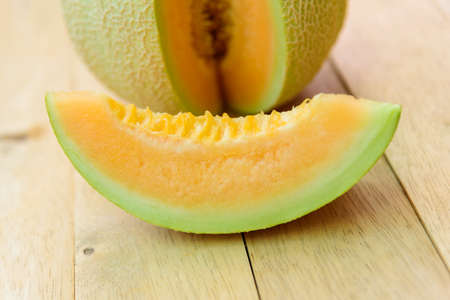 a lot of piece of fresh orange melon on the plateの写真素材