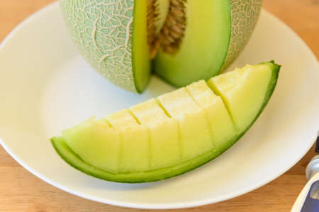 a piece of fresh green melon in dishの写真素材