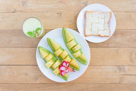 a piece of fresh green melon in dishの写真素材