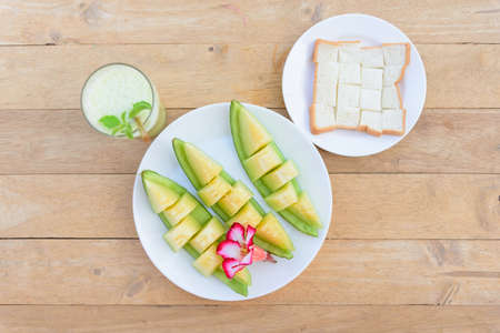 a piece of fresh green melon in dishの写真素材