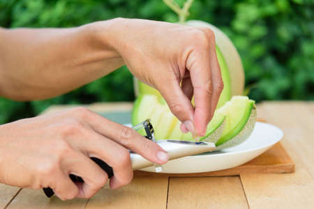 Drop the juice of fresh melon for test sweet levelの写真素材