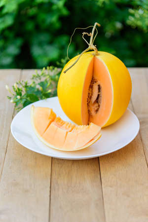 a lot of piece of fresh orange melon on the plateの写真素材