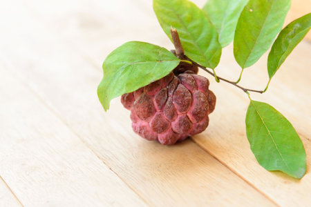 Pink custard apple on the wood plate