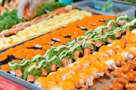Closeup focus to row of sushi menu  in the trayの写真素材