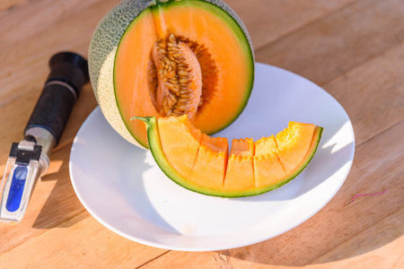 a lot of piece of fresh orange melon on the plateの写真素材