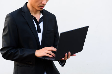 Businessman working on laptop computer on white background with copy space.の写真素材