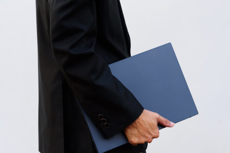 business man carry laptop on his handの写真素材