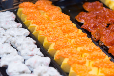Closeup focus to row of sushi menu  in the trayの写真素材