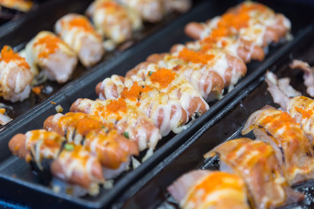 Closeup focus to row of sushi menu  in the trayの写真素材