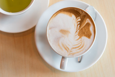 hot cappuccino coffee with green tea on tableの写真素材