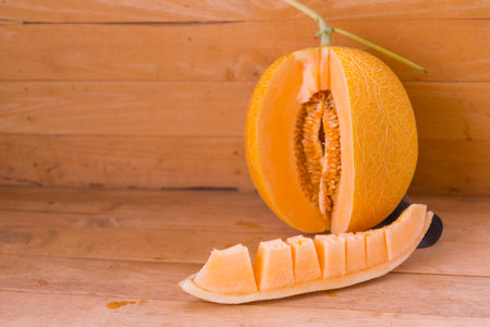 a lot of piece of fresh orange melon on the plateの写真素材