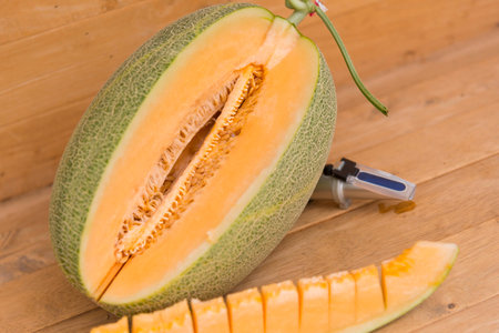 split the orange melon on wood plateの写真素材