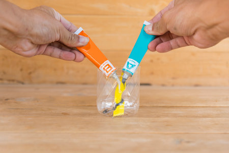 Mixing the epoxy glue for stick the steel partの写真素材