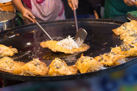 Chef cooking the Fried oysters best delicious menu of street food in Thailandの写真素材