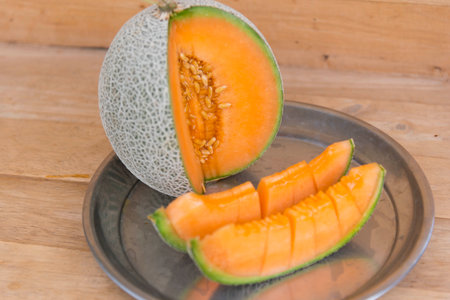a lot of piece of fresh melon on the plateの写真素材