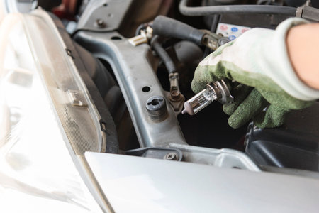 The man replace car headlight bulbの写真素材