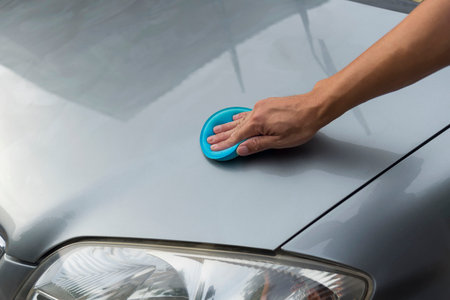 The man Wax and polish the car by handの写真素材