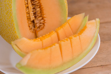 split the orange melon on wood plate