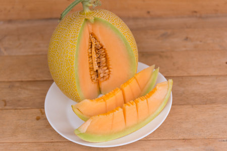 a lot of piece of fresh melon on the plateの写真素材