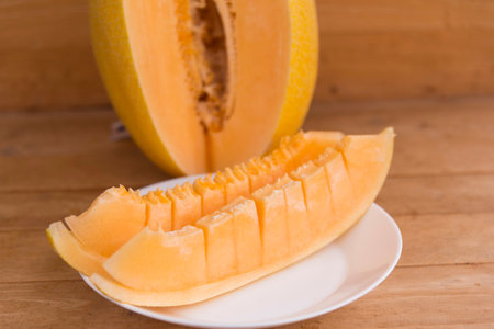 a lot of piece of fresh melon on the plateの写真素材