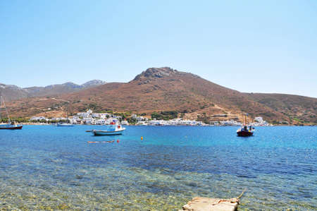 Katapola village next to the sea with the mountainous and rocky の写真素材