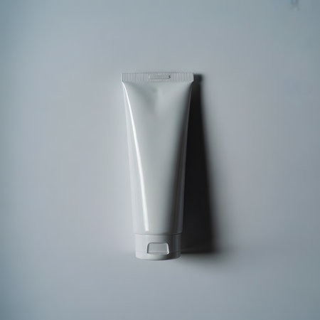 A clean, bright white cosmetic squeeze tube with a fliptop cap, isolated on a plain white background, perfect for product mockups and design presentationsの素材