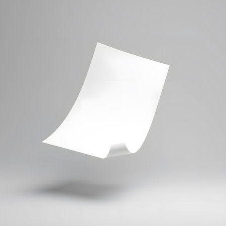 A single sheet of white paper with a gentle curve, suspended in the air with a subtle shadow on a plain grey studio backdrop, evoking a sense of calmの素材