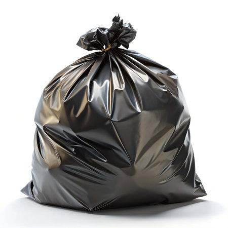 A full black garbage bag, tied at the top with its drawstring, isolated on a clean white background, representing waste and disposalの素材
