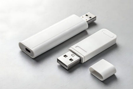 Two white USB flash drives on a metal background, close-upの素材