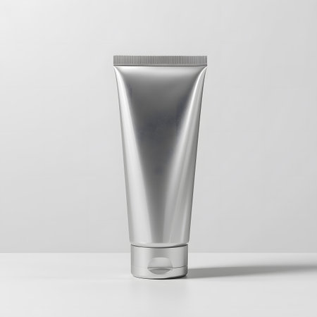 A plain silver metallic cosmetic tube with a fliptop cap, isolated on a white background, showcasing a minimalist and clean product design for skincare or beauty applicationsの素材