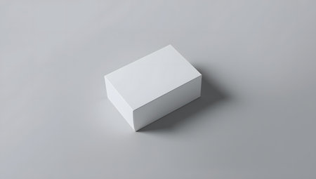 A stack of blank white business cards on a plain grey background, perfect for mockups and branding presentationsの素材