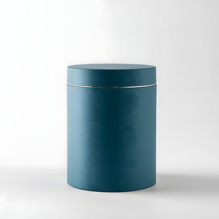 Elegant dark teal cylindrical jar with a metallic silver accent band, isolated on a plain white studio background, suitable for cosmetics or storageの素材