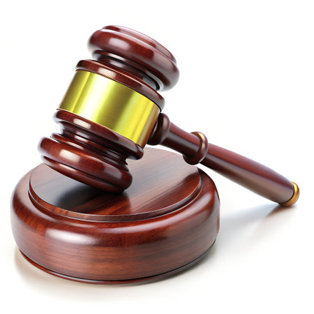 A wooden judges gavel resting on its sound block, representing authority and legal decisions, isolated on white backgroundの素材