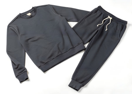 A dark grey crewneck sweatshirt and matching sweatpants laid out on a white background, showcasing a comfortable and casual loungewear setの素材