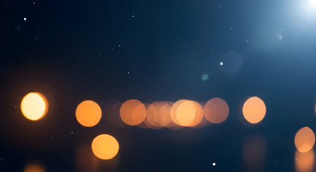 A mesmerizing bokeh effect creates a dreamy atmosphere with soft, glowing lights against a dark blue backdropの素材
