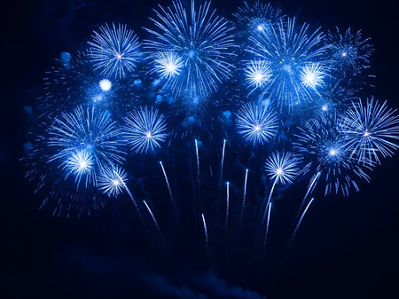 Spectacular vibrant blue fireworks illuminating the night sky during a festive celebration, perfect for new year's eve, holidays, and events.の素材