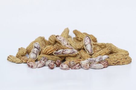 Heap of Peanuts isolated on white backgroundの写真素材