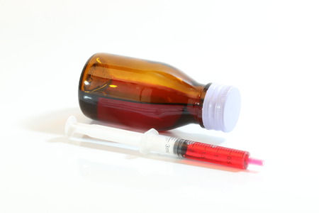 Bottle pouring Medicine Syrup in Spoonの写真素材