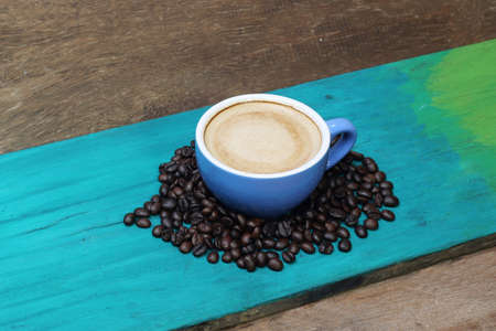 close up top view coffee cup on green wood backgroundの写真素材