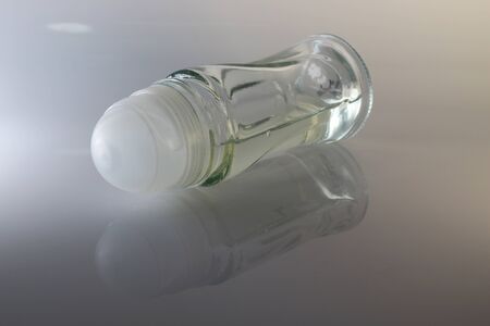 A closeup shot of a clear liquid roll-on deodorant bottle
