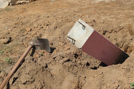 A shovel to dig a hole to bury a concrete pillar.の写真素材