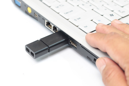 USB flash drive stick being connected to laptop computer