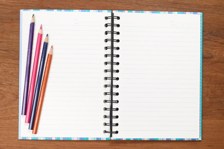 Notebook with colored wooden flooring.