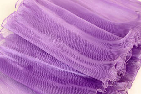 Pressing on a purple chiffon white background.の写真素材