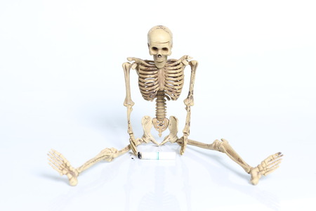 Three human skeletons with cigarettes.の写真素材