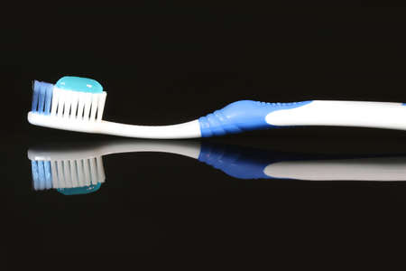 toothpaste toothbrush on black backgroundの写真素材