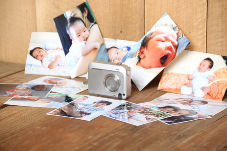 Digital cameras, photo boy and his mother on the wooden floor.の写真素材